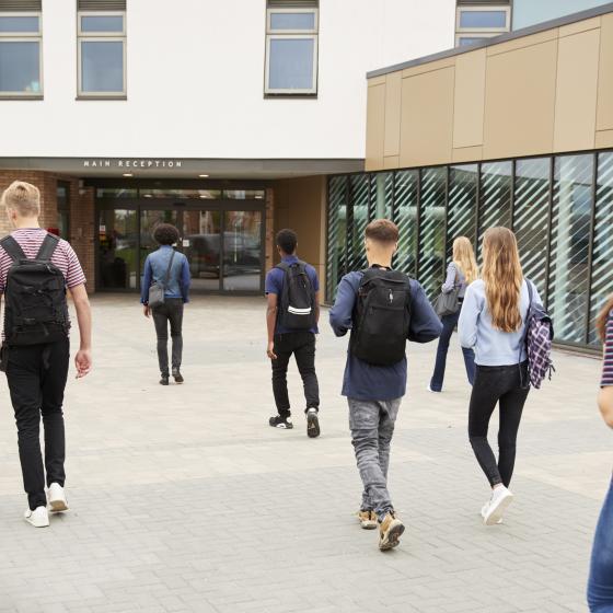 teenagers walking into school