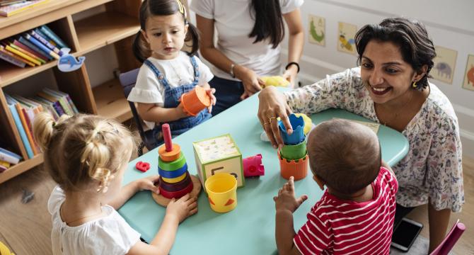 pre-schoolers in play group with teacher