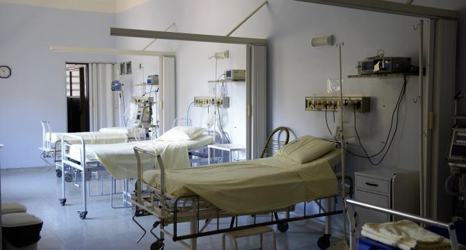 Photo of three empty hospital beds in a clinic